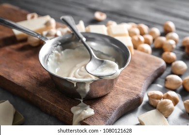 Dish With Melted White Chocolate On Wooden Board