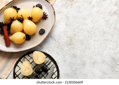 Dish and plate with delicious poached pears, prunes, anise and cinnamon on light table