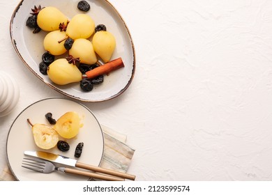 Dish and plate with poached pears and prunes on light table
