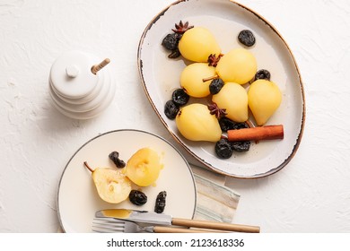 Dish with poached pears and jar with honey on light table