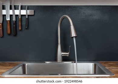 Dish sink with running water in a chef's kitchen