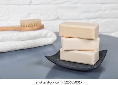 Dish with soap bars on grey table. Space for text
