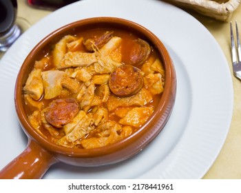 Dish Of Spanish Cuisine. Stewed Tripe (Callos) In Salsa With Garbanzos And Chorizo Sausage Served In Clayware..