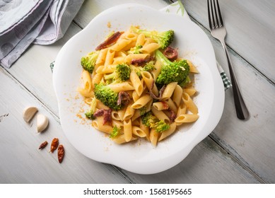 Dish Of Spicy Penne Pasta With Broccoli And Guanciale, Italian Cuisine 