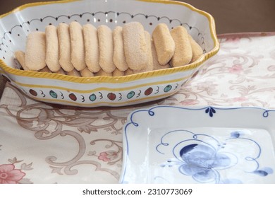 A dish with sponge cookies in close-up on the background of a beautiful plate - Shutterstock ID 2310773069