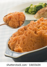 Dish Of Sweet Potato Mash With A Spoon