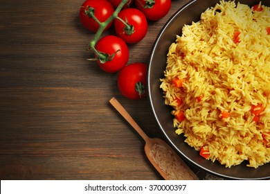 Dish Of Vegetarian Rice On Wooden Background