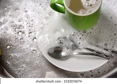 Dish Washing. Soaking In The Kitchen Sink. After The Dinner It's Time To Do The Dishes 