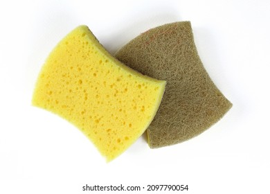 Dish washing sponge on a white background. Two sponges made of parolon and sisal close-up. A sponge with a yellow soft and brown hard side. 