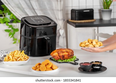 dishes cooked in the airfryer on the kitchen table - Shutterstock ID 1855341841