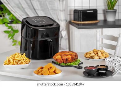 dishes cooked in the airfryer on the kitchen table - Shutterstock ID 1855341847