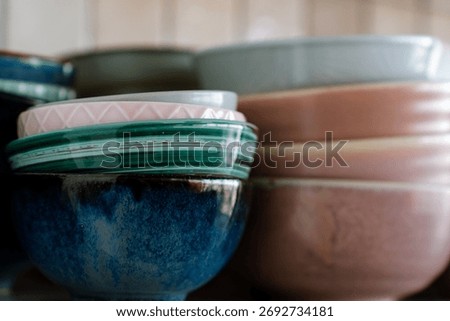 Dishes on the shelf, a stack of clean plates and bowls.