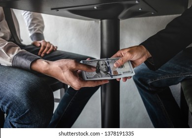 Dishonest cheating in business illegal money, Businessman receive bribe money under table to business people to give success the deal contract of investment, Bribery and corruption concept. - Shutterstock ID 1378191335