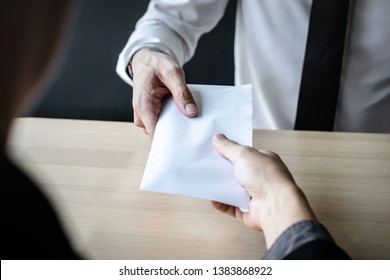 Dishonest cheating in business illegal money, Businessman giving bribe money in envelope to business people to give success the deal contract of investment, Bribery and corruption concept. - Shutterstock ID 1383868922