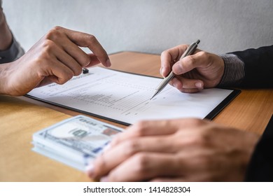 Dishonest cheating in business illegal money, Businessman giving bribe money in envelope to business people to give success the deal contract of investment, Bribery and corruption concept. - Shutterstock ID 1414828304