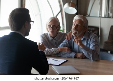 Dishonest contractor. Angry elderly couple sit at broker manager office demand compensation for breach of contract bad service. Annoyed mature spouses scam victims complain lawyer on commercial fraud - Shutterstock ID 2064964967