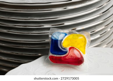 Dishwasher Detergent Pod With Stack Of Plates