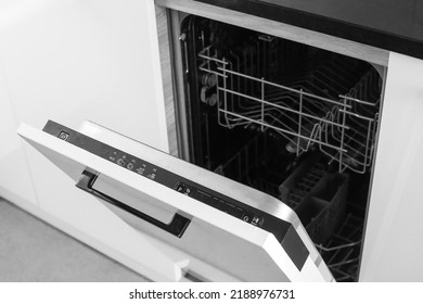 Dishwasher. Loading dishes. Dishwashing capsules. Open dishwasher with clean dishes in the white kitchen. Opening and closing the dishwasher.