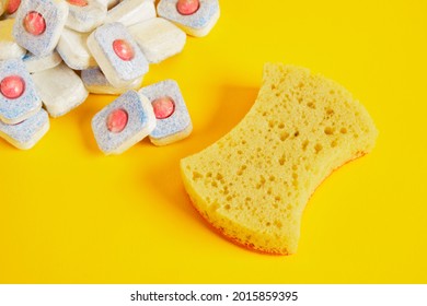 Dishwasher Tablets And Dishwashing Sponge On Yellow Background, Dishwashing Products, Hand Wash Dishes Or Use Dishwasher