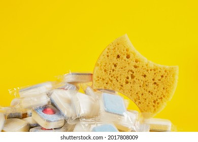 Dishwasher Tablets And Dishwashing Sponge On Yellow Background, Dishwashing Products, Hand Wash Dishes Or Use Dishwasher