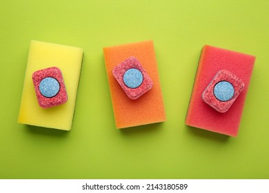 Dishwasher Tablets On A Dishwashing Sponges On A Green Background, Dishwashing Products. Top View