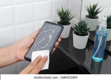 Disinfect, Sanitize, Hygiene Care. Cleaning Dirty Stain On Mobile Phone Touch Screen For Disinfection, Prevention Of Germs Spreading During Infections Of COVID-19 Coronavirus