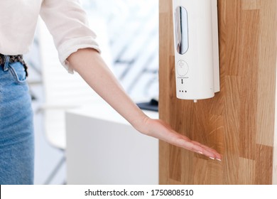 Disinfectant Liquids In Public Place At Reception. Woman Washing Hands With Antibacterial Sanitizer. Hygiene, Disinfection, Staff Safety In Office. Protection Employees On Workplace During Quarantine.