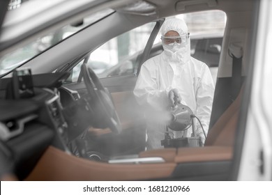 Disinfectant worker character in protective mask and suit sprays bacterial or virus in a car. - Shutterstock ID 1681210966