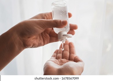 Disinfecting hands. Taking disinfection alcohol gel on hands in white light to prevent virus epidemic. Prevention of flu disease. Cleaning and disinfecting hands in proper way.