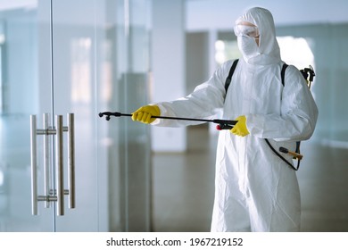 Disinfecting of office to prevent COVID-19, Man in protective hazmat suit with with spray chemicals to preventing the spread of coronavirus, pandemic in quarantine city. - Powered by Shutterstock