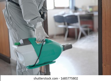 Disinfecting of office to prevent COVID-19, person in white hazmat suit with disinfect in office, coronavirus concept - Shutterstock ID 1685775802