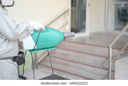 Disinfecting Of Office To Prevent COVID-19, Person In White Hazmat Suit With Disinfect In Office, Coronavirus Concept