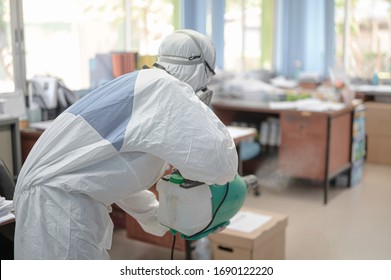 Disinfecting Of Office To Prevent COVID-19, Person In White Hazmat Suit With Disinfect In Office, Coronavirus Concept