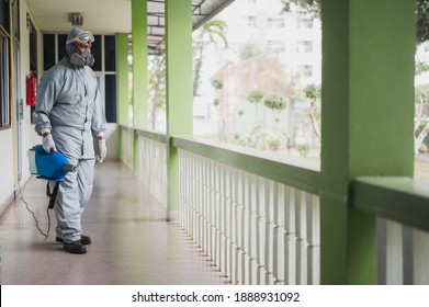 Disinfecting of office to prevent COVID-19, person in white hazmat suit with disinfect in office, coronavirus healthcare system concept - Shutterstock ID 1888931092