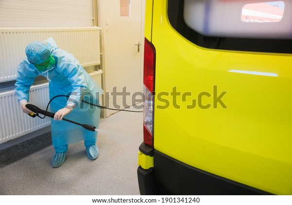 Disinfection of the ambulance.  Inscription\
on the car: Resuscitation. Emergency medical\
care