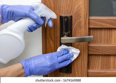 Disinfection, cleaning and washing of door handles. 
Prevention of coronavirus infection - Shutterstock ID 1674169888