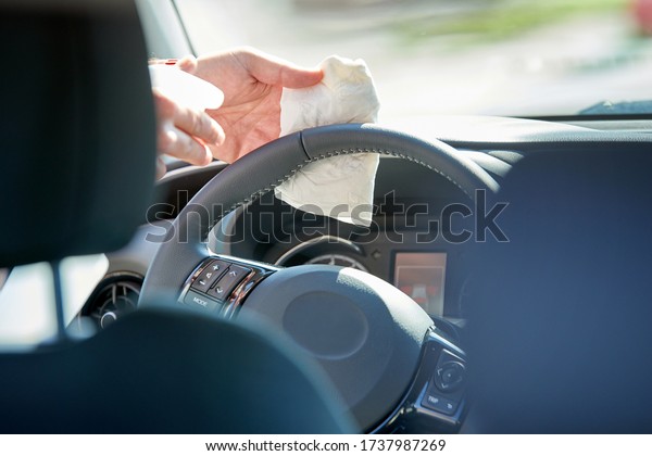 Disinfection of the interior of a driving school\
car, during the Coronavirus\
time
