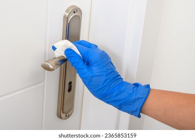Disinfection of metal door handles - Shutterstock ID 2365853159