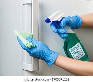 Disinfection Of The Refrigerator Door During A Coronavirus Pandemic. Clean Fridge Door Handle. Sterile Cleaning In The House.