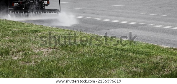 Disinfection truck - Cleaning machines\
washes the city asphalt road with water spray. copy\
space