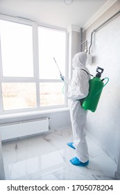 disinfector in a protective suit conducts disinfection in contaminated area. professional disinfection against COVID-19, coronavirus. in clothing protecting from chemical poisoning in the industry - Shutterstock ID 1705078204