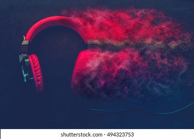 Disintegration effect photo manipulation applied to red headphones