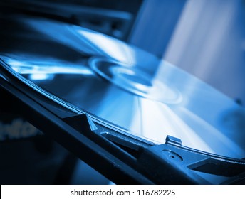Disk in dvd-rom in blue colors - Powered by Shutterstock