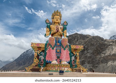 Diskit Monastery, Front view of 108 feet tall statue of Maitreya Buddha in Nubra Valley, Ladakh, India, Buddha Statue with beautiful Himalayas and dramatic clouds in Nubra valley in the background