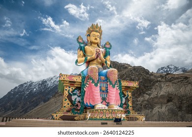 Diskit Monastery, Front view of 108 feet tall statue of Maitreya Buddha in Nubra Valley, Ladakh, India, Buddha Statue with beautiful Himalayas and dramatic clouds in Nubra valley in the background