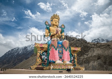 Diskit Monastery, Front view of 108 feet tall statue of Maitreya Buddha in Nubra Valley, Ladakh, India, Buddha Statue with beautiful Himalayas and dramatic clouds in Nubra valley in the background