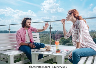 Dislike Of Manners. Curly Handsome Man Not Liking Manners Of His Girlfriend While Having Romantic Lunch.