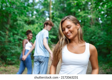 Disloyal Man Looking At Another Woman While Walking With His Girlfriend In Park