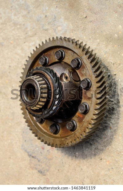 Dismantled box car\
transmissions. The gears on the shaft of a mechanical transmission.\
Gear with bearings