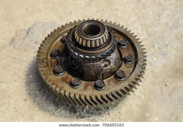 Dismantled box car\
transmissions. The gears on the shaft of a mechanical transmission.\
Gear with bearings